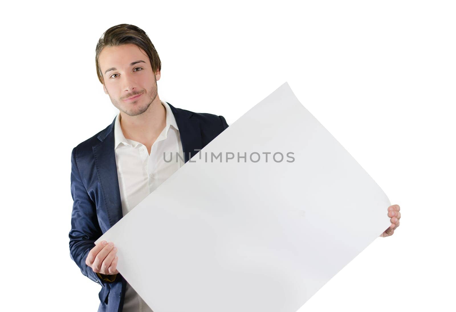Attractive young man holding and showing empty, blank white board, sign or paper sheet
