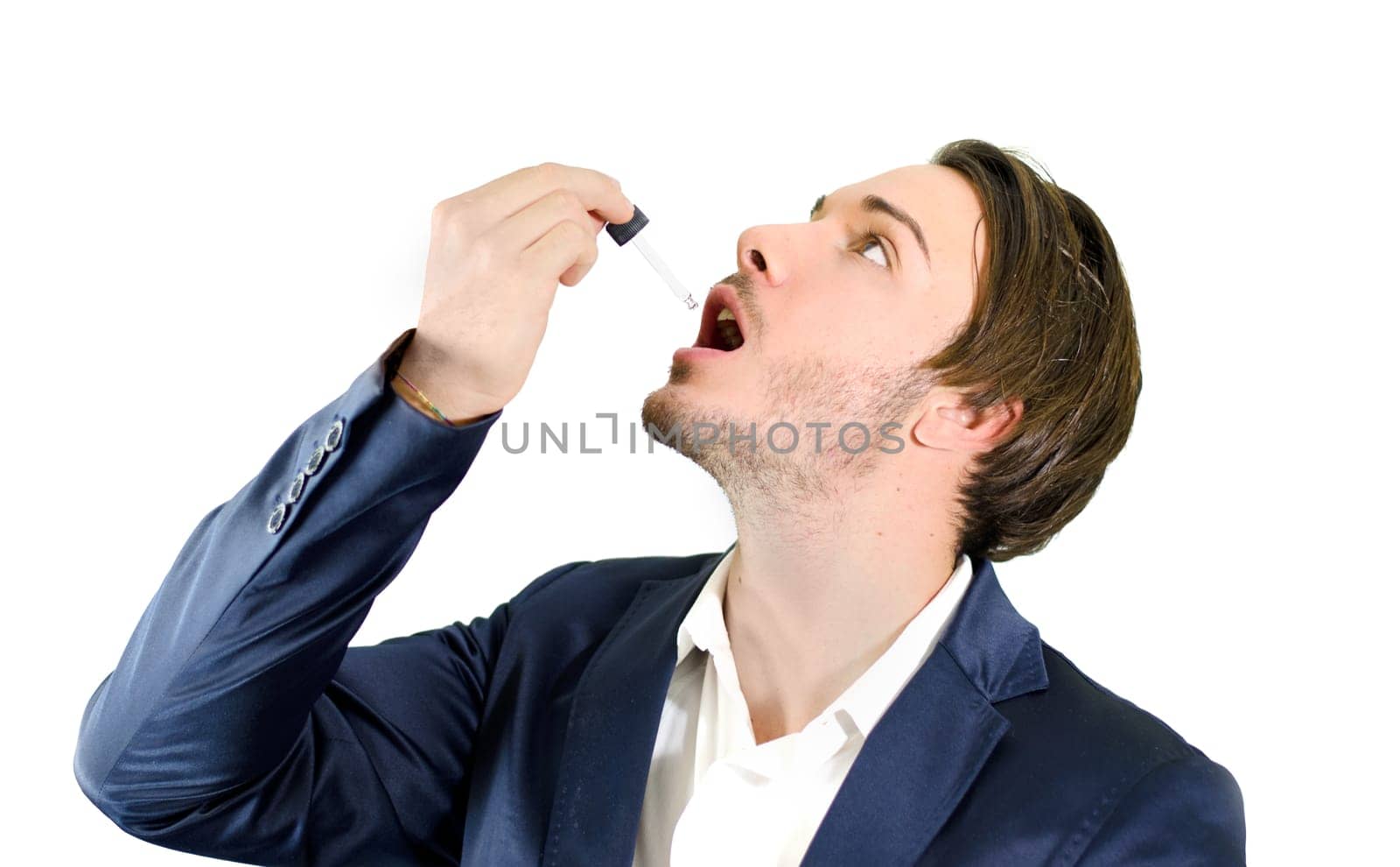 Young man using dropper pipette on his mouth for medicine, drug treatment