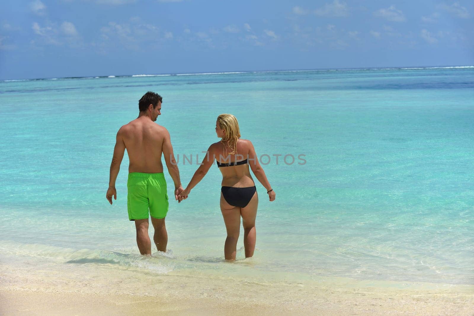 happy young  couple at summer vacation have fun and relax at beautiful sunny  day on beach