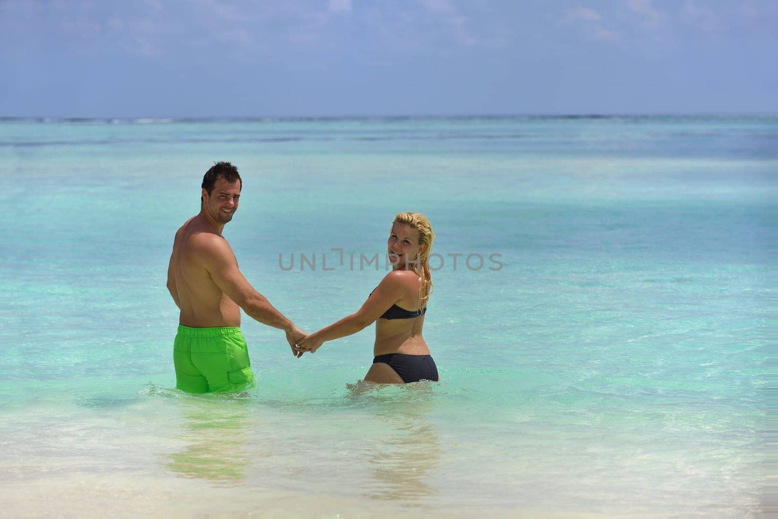 happy young  couple at summer vacation have fun and relax at beautiful sunny  day on beach