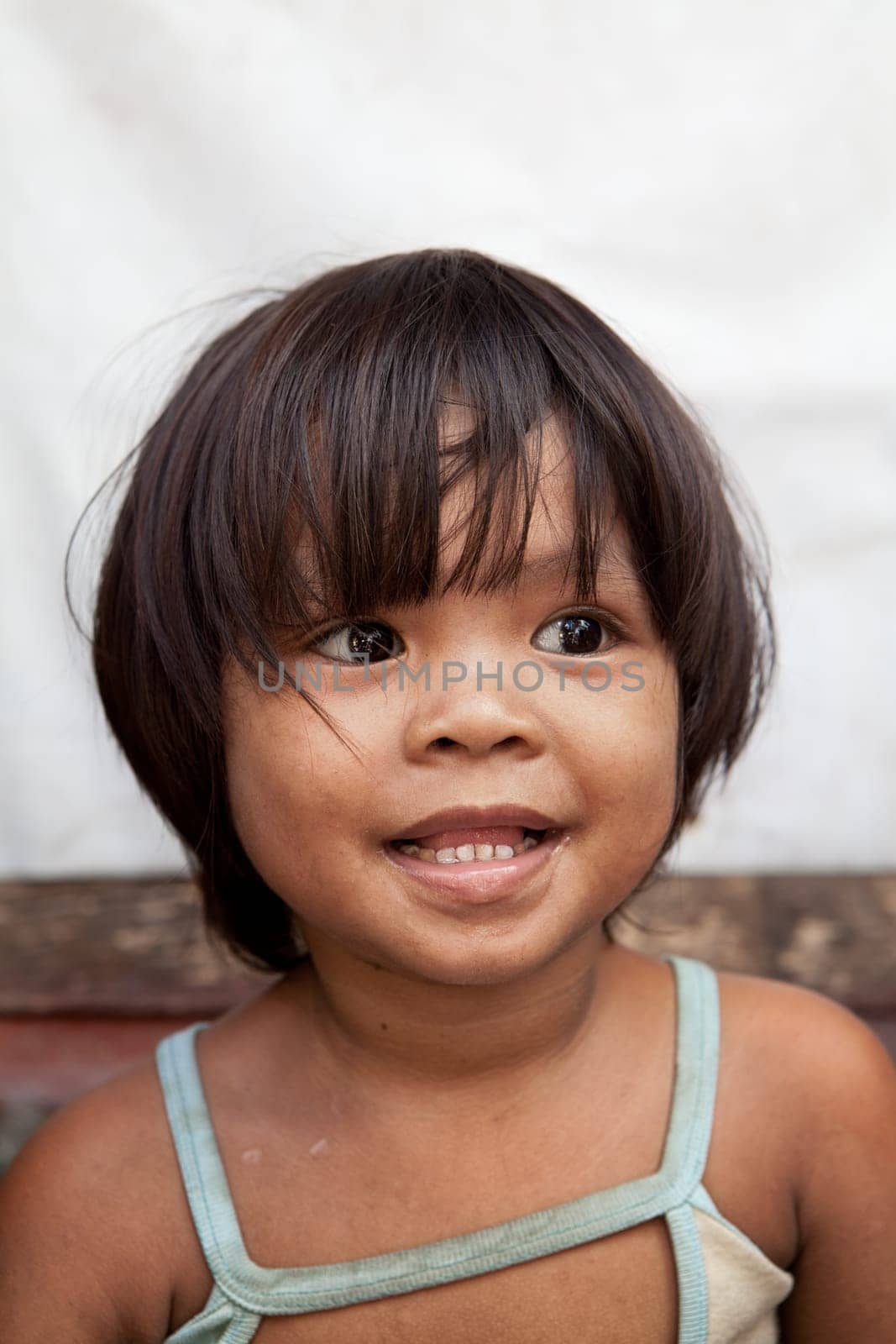 Portrait of an adorable Asian girl from impoverished area in the Philippines.