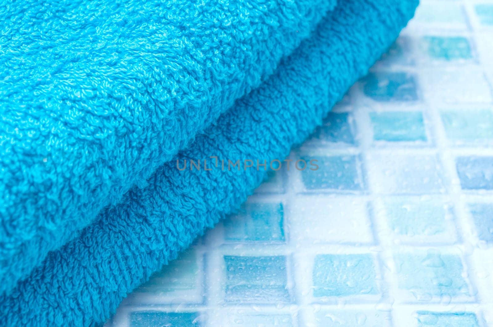 Blue Bath Towels on Blue Bathroom Tiles
