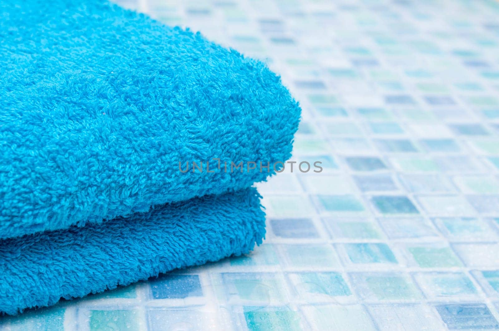 Blue Bath Towels on Blue Bathroom Tiles