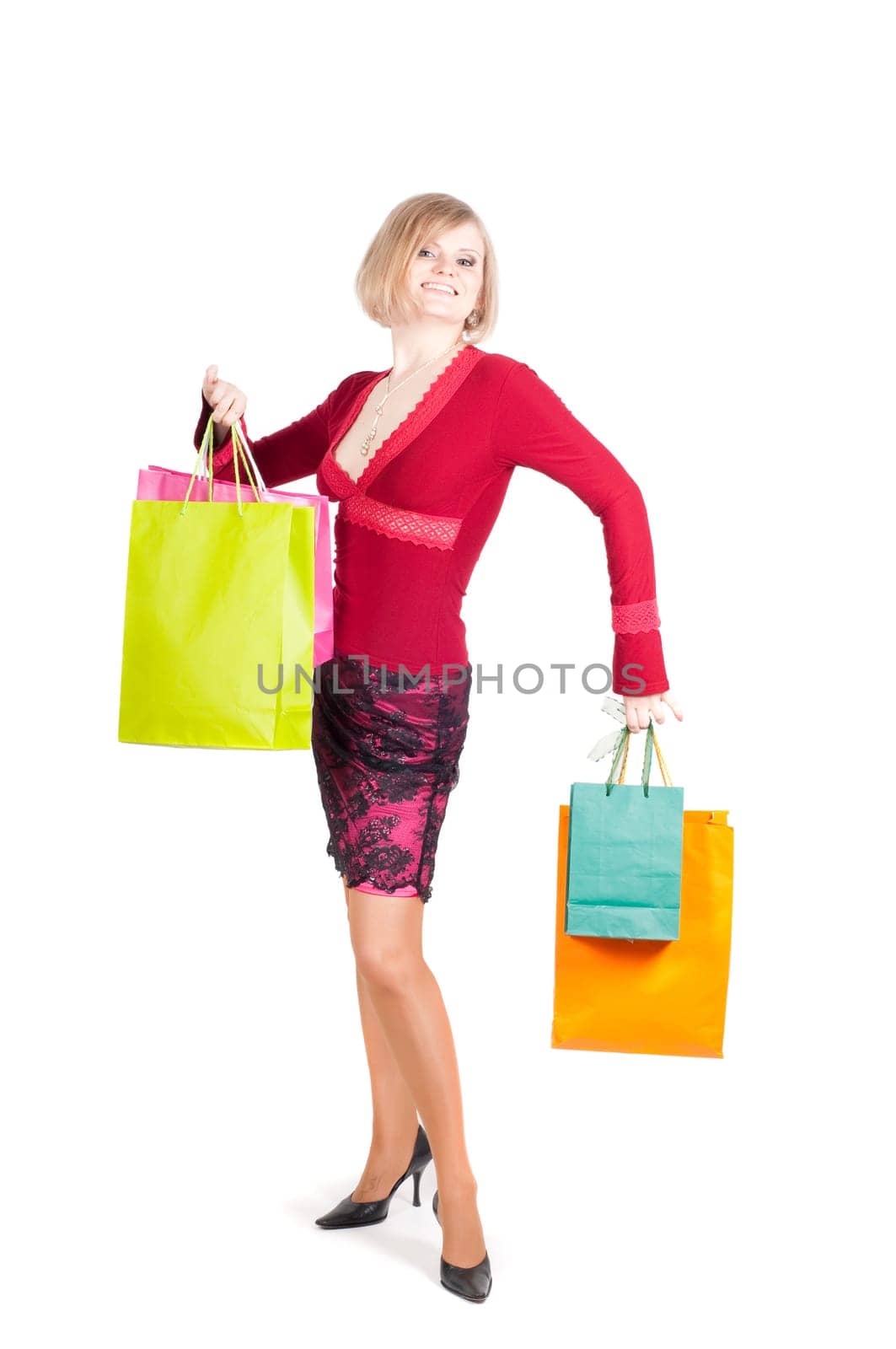 Beautiful woman with multicolored shopping bags isolated onwhite