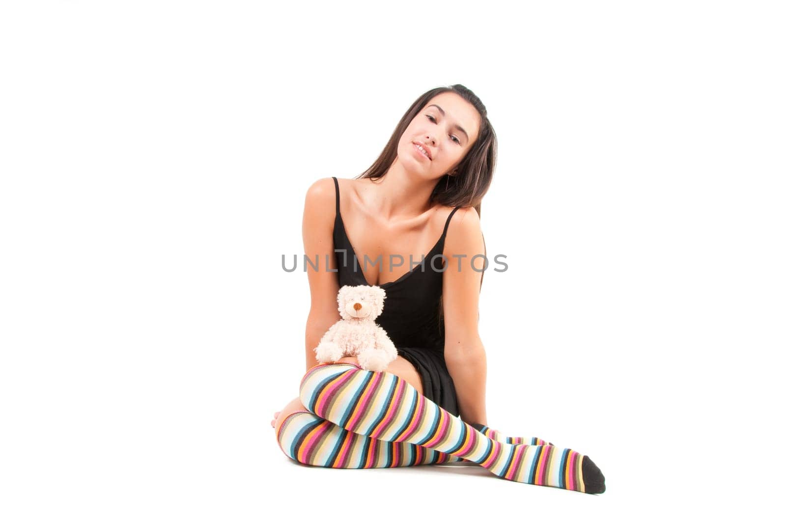 Shot of woman in multicolored stockings sitting onthe floor