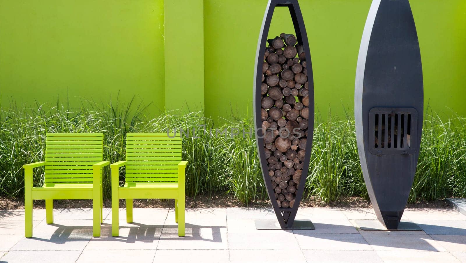 Modern garden with green wall, green funiture and fire place