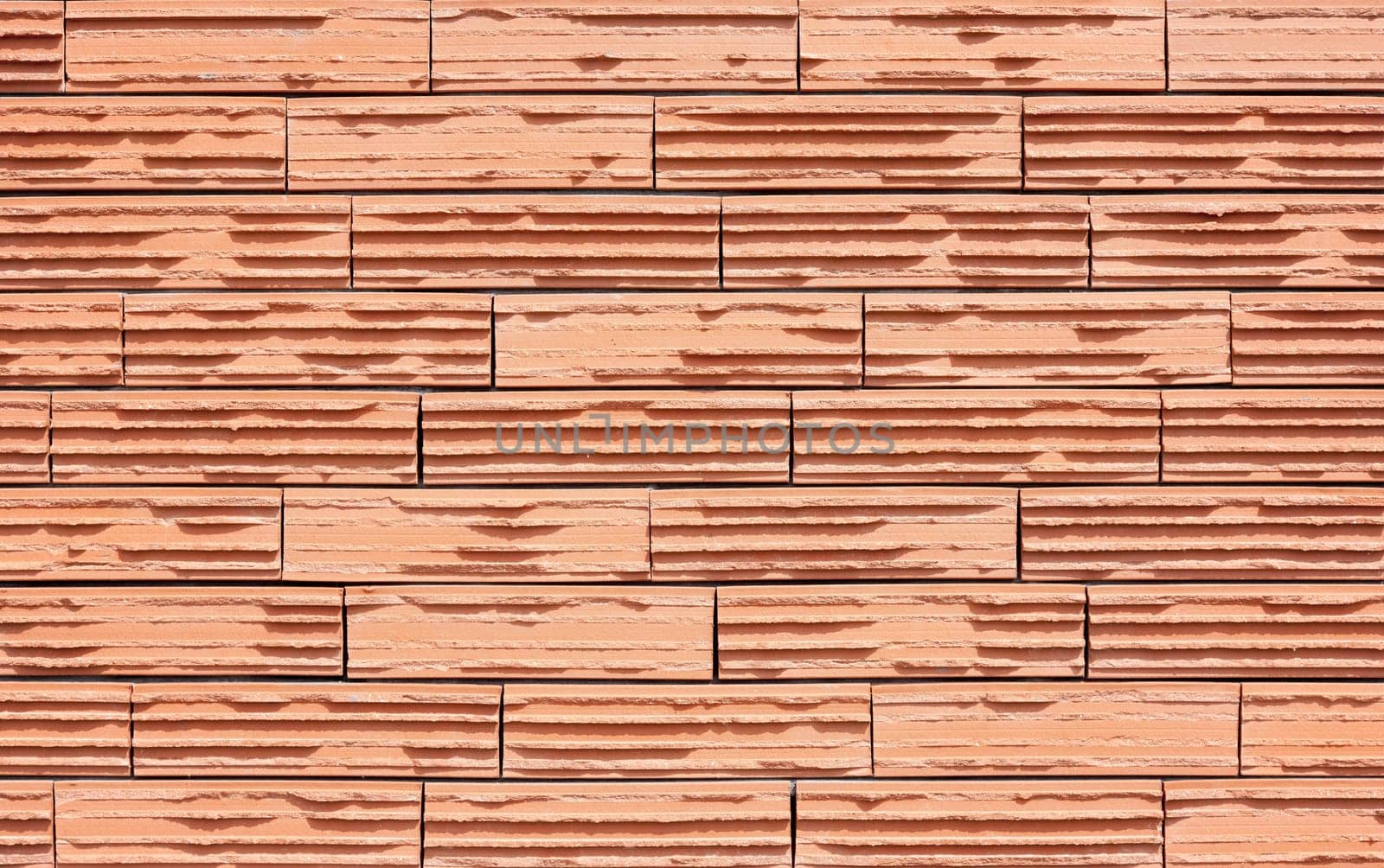 Modern wall with orange ribbed bricks