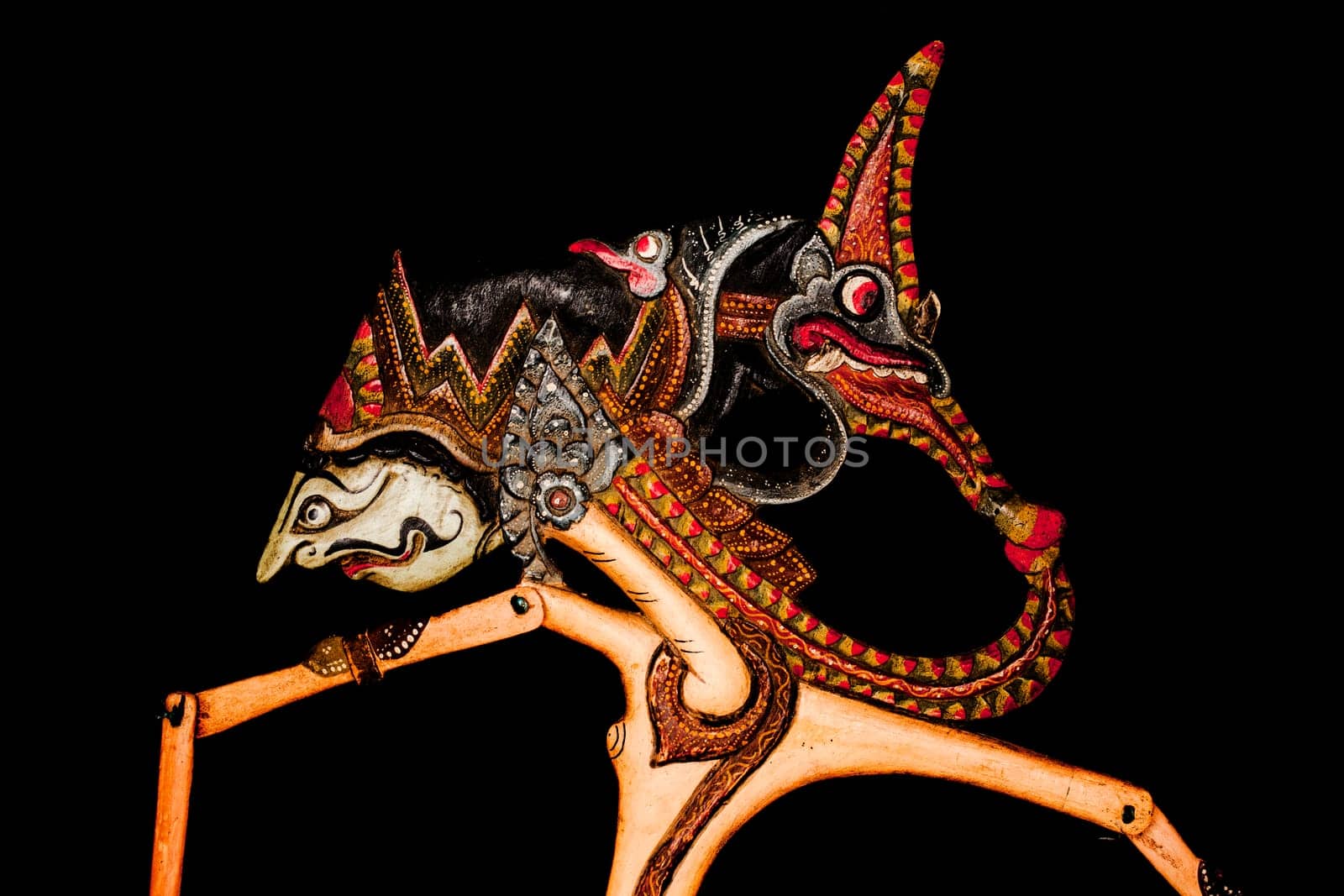 Traditional Indonesian wayang with batik motif on black background