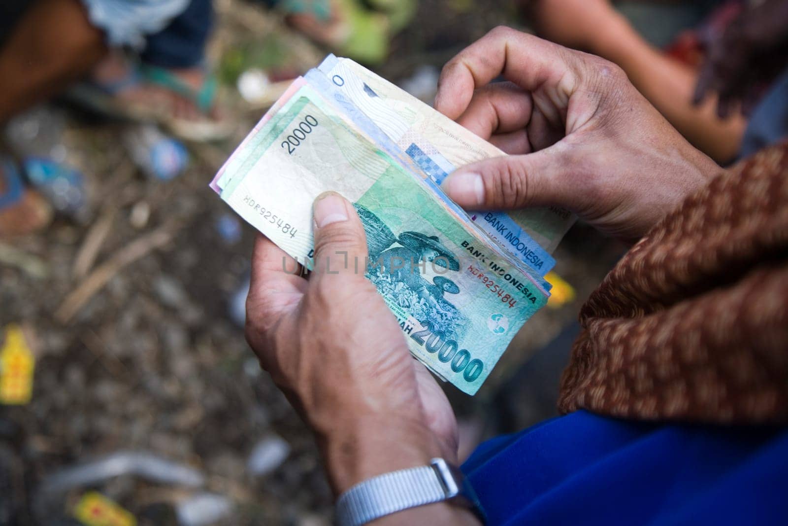 Counting money during a cock fight in Sulawsi, Indonesia