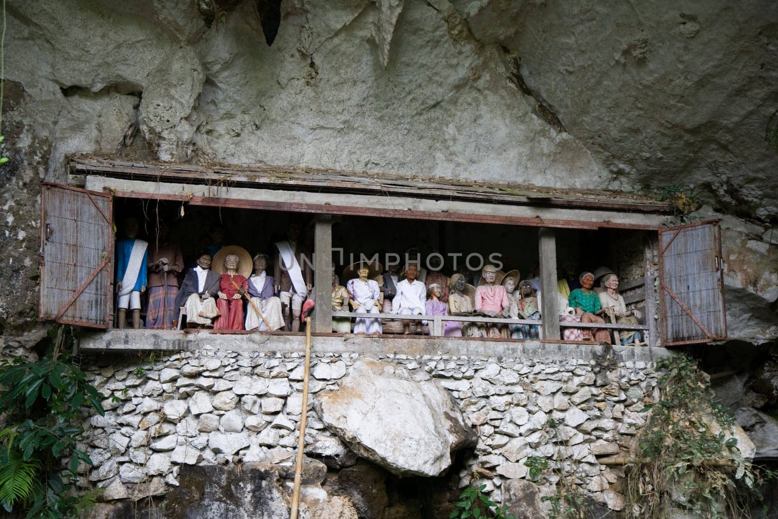 Wood carved effigy, called tau tau placed in the cave looking out over the land