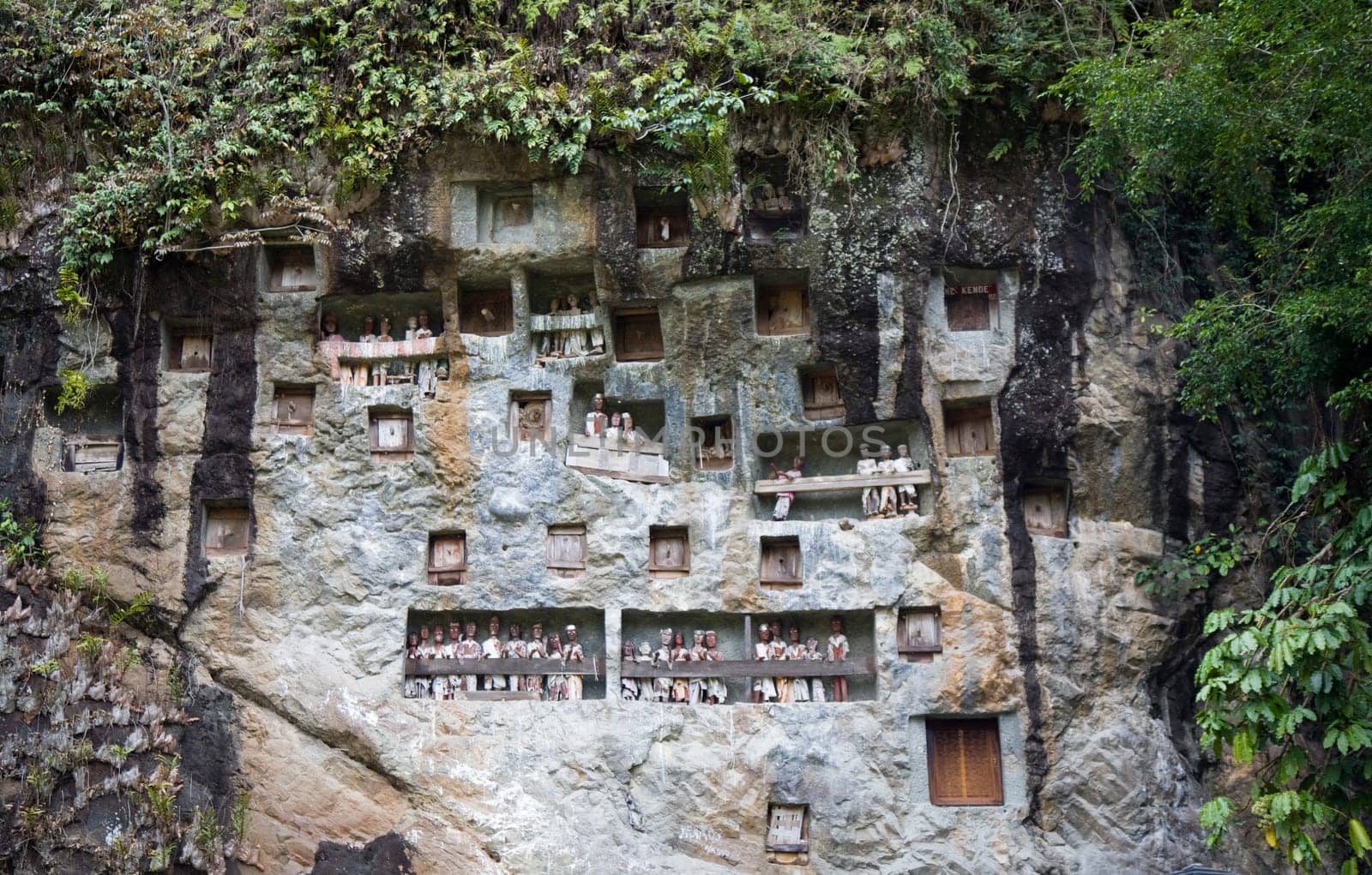 Wood carved effigy, called tau tau placed in the cave looking out over the land