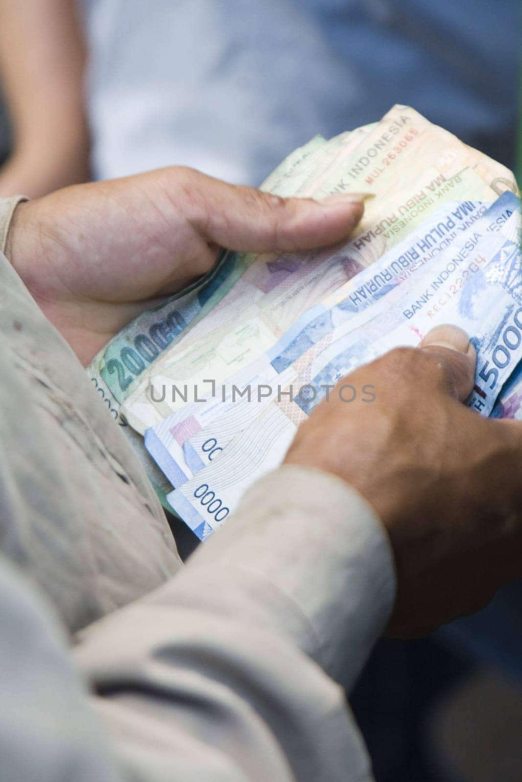 Counting money during a cock fight in Sulawsi, Indonesia