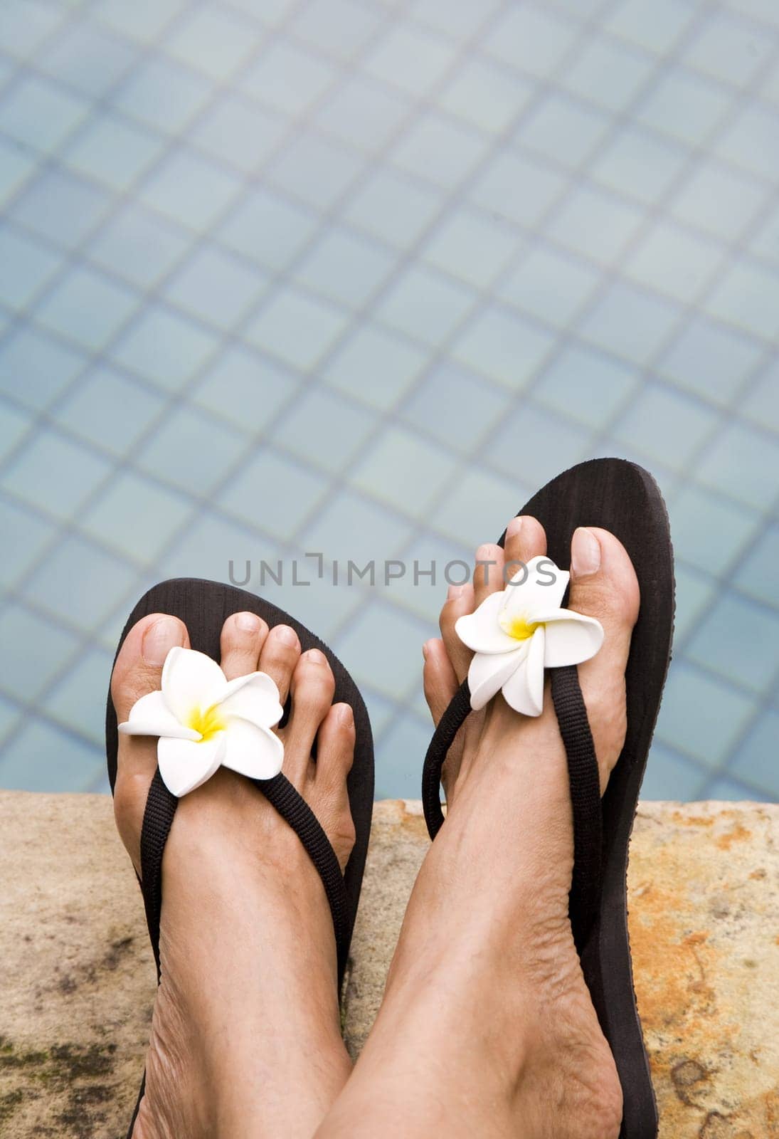 Relaxing on the side of the swimming pool