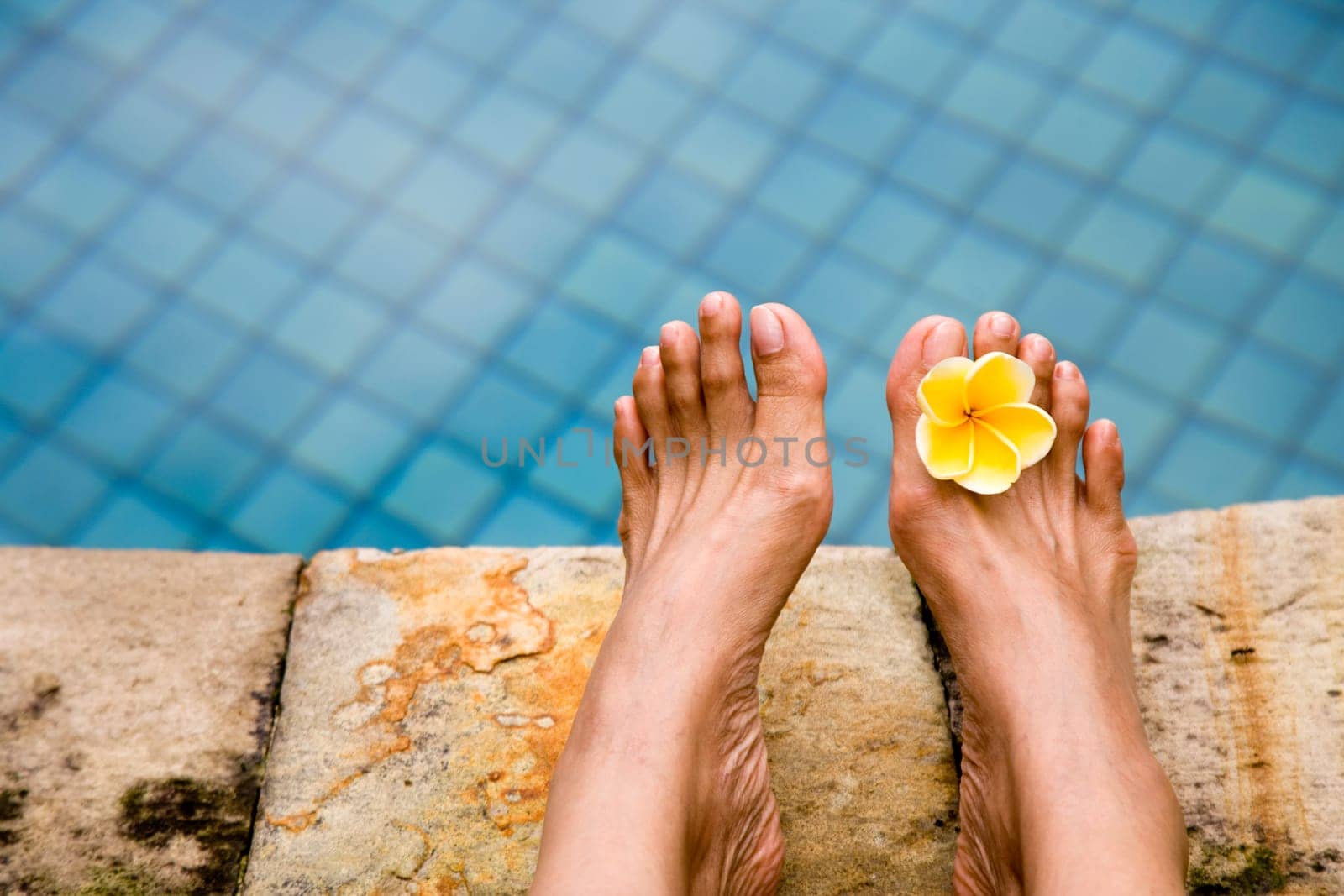 Relaxing on the side of the swimming pool