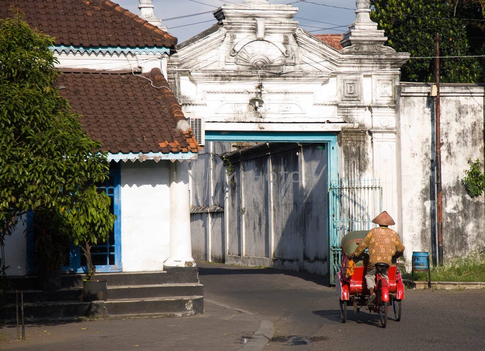 Street scene with becak in the Kraton area in Solo, Indonesia