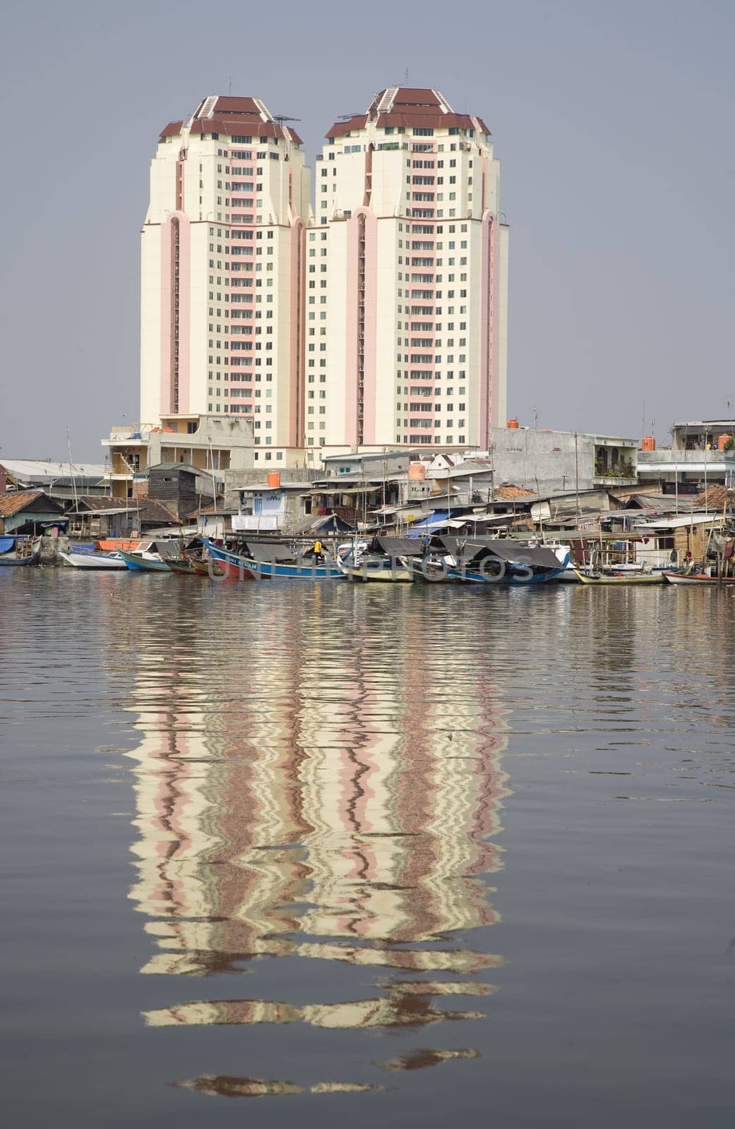 Slum area with apartments in the background in Jakarta, Indonesia