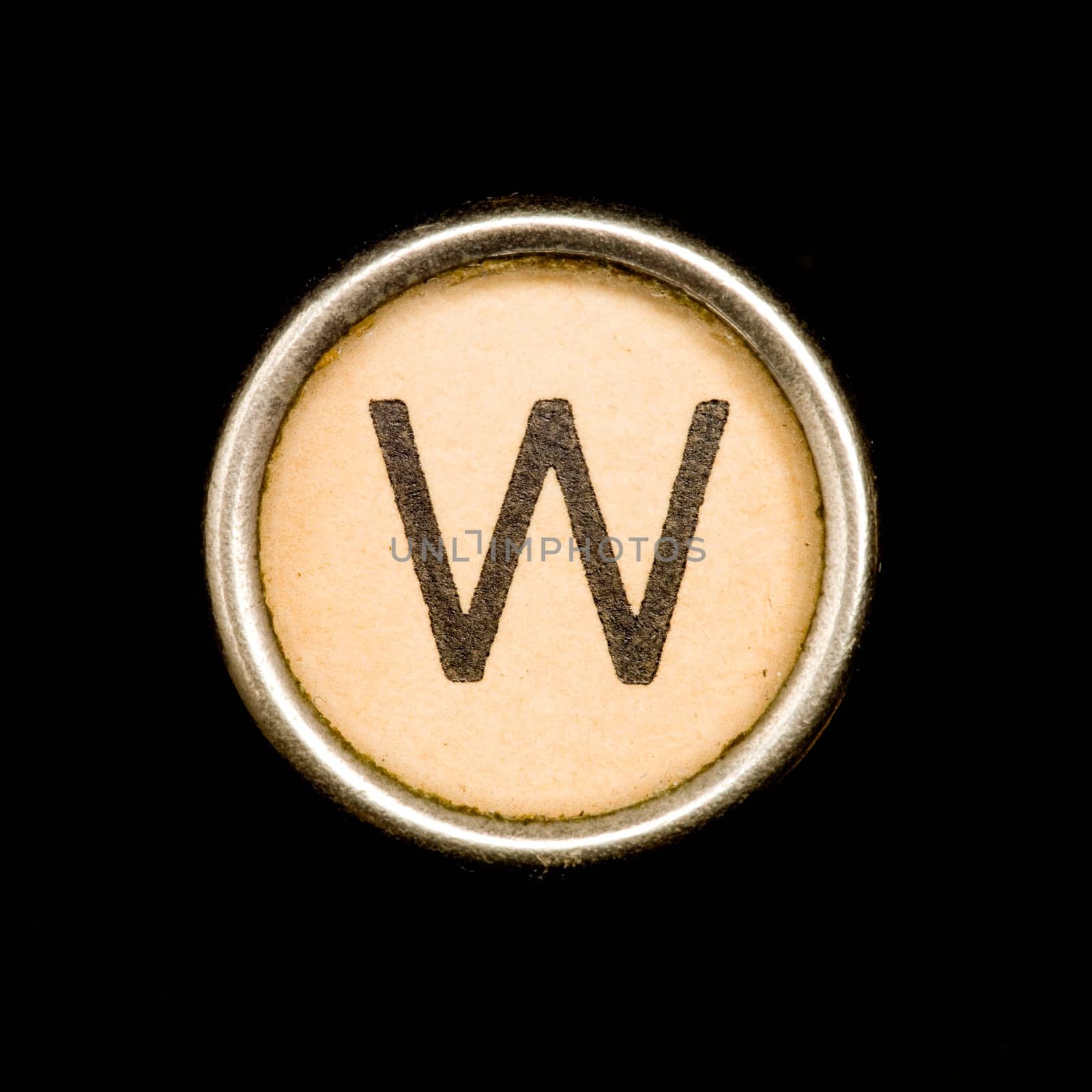 The W button on a complete alphabet of an antique typewriter