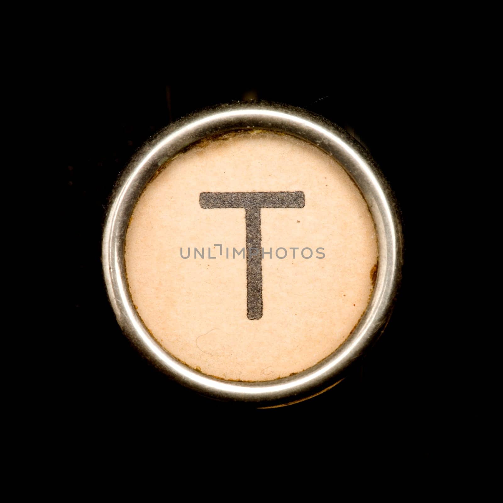 The T button on a complete alphabet of an antique typewriter