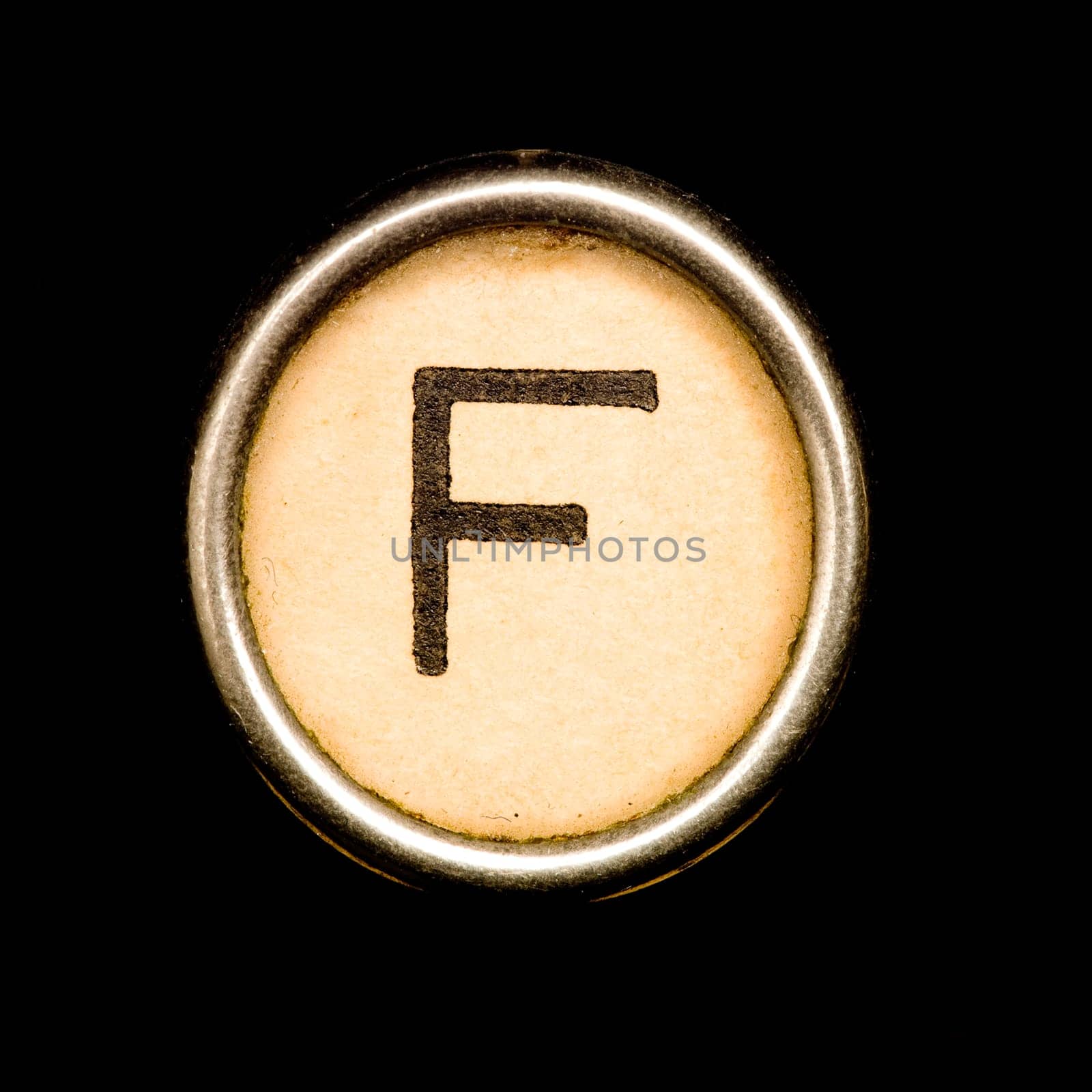 The F button on a complete alphabet of an antique typewriter