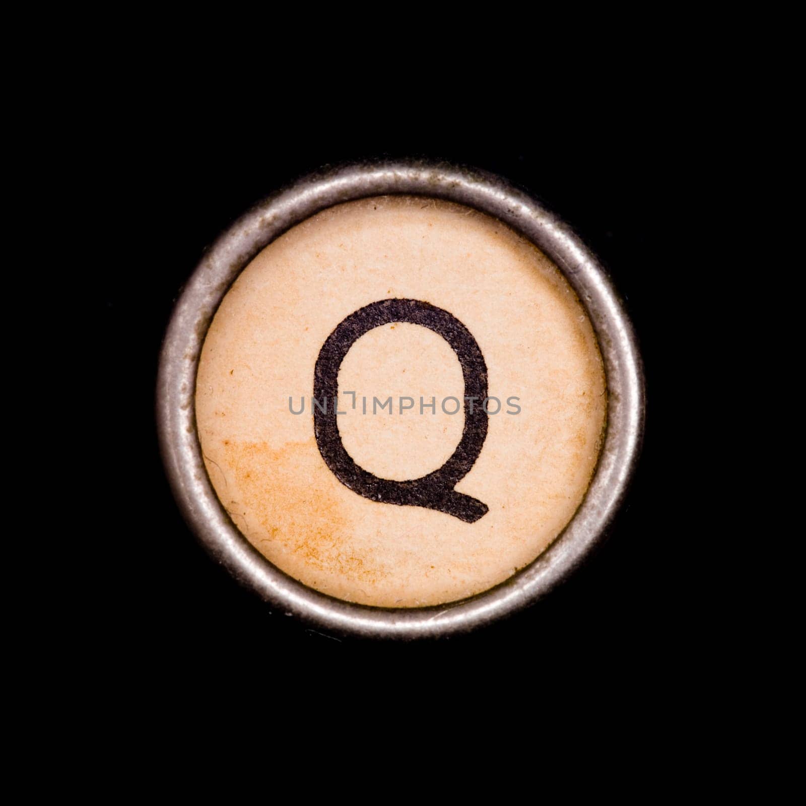 The Q button on a complete alphabet of an antique typewriter