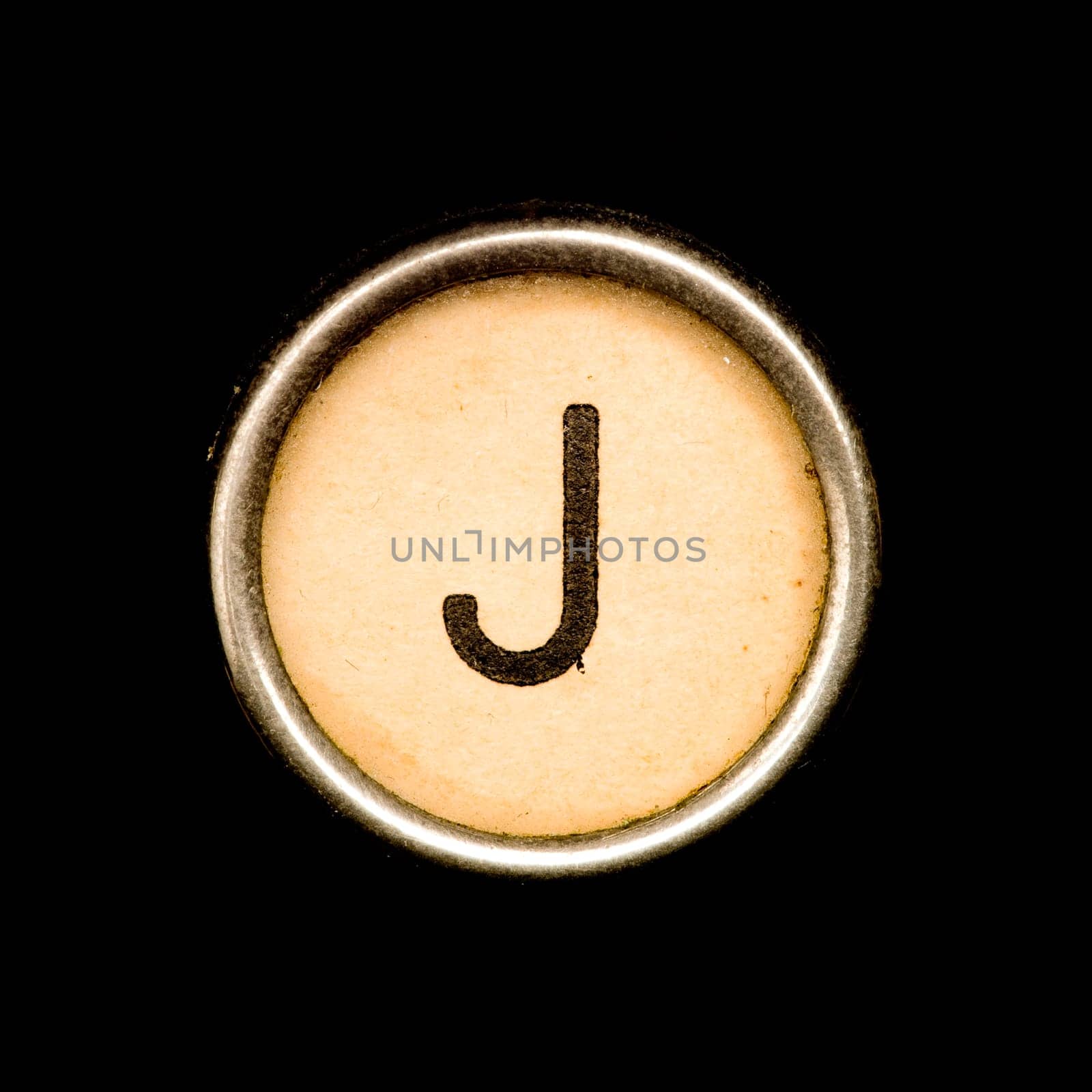 The J button on a complete alphabet of an antique typewriter