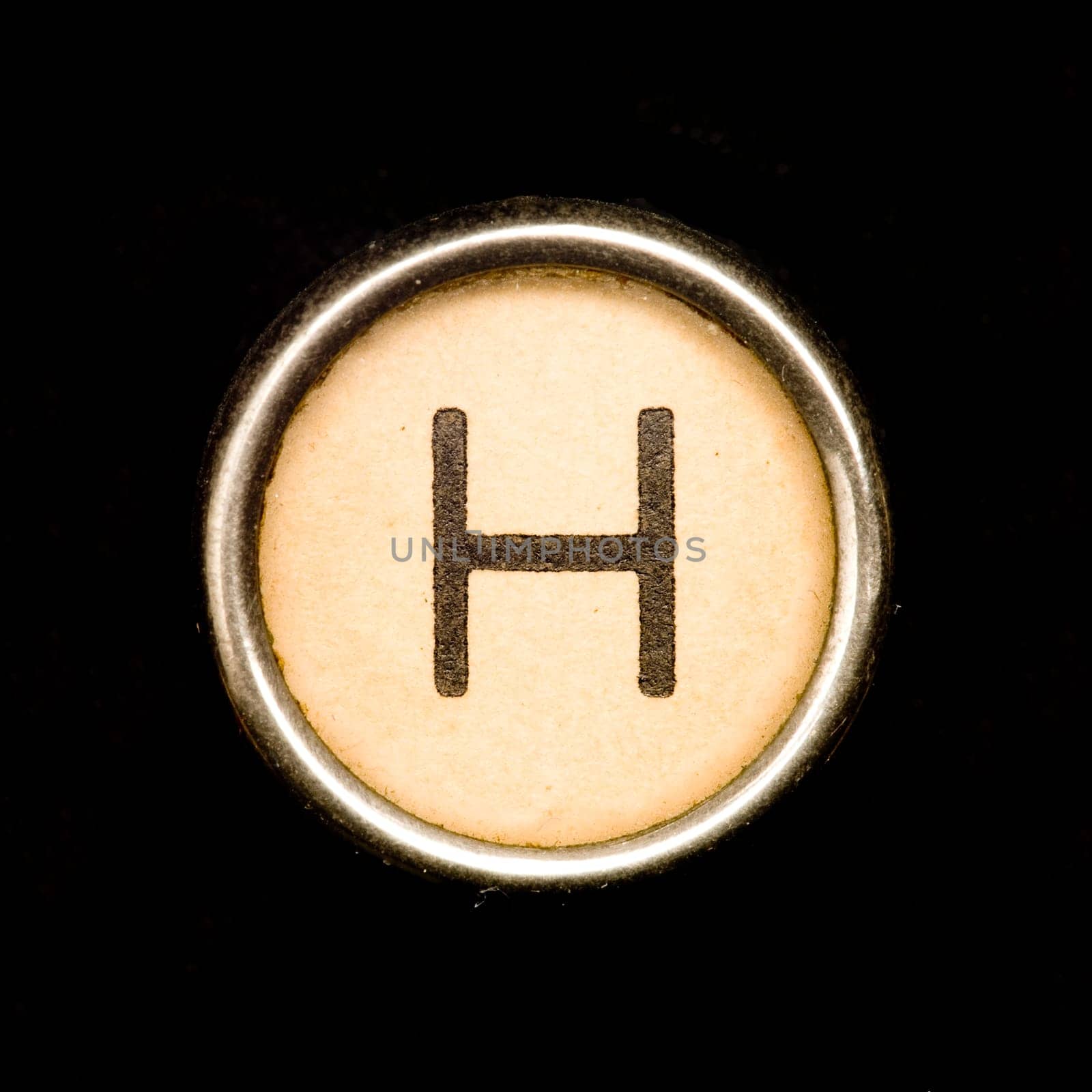The H button on a complete alphabet of an antique typewriter