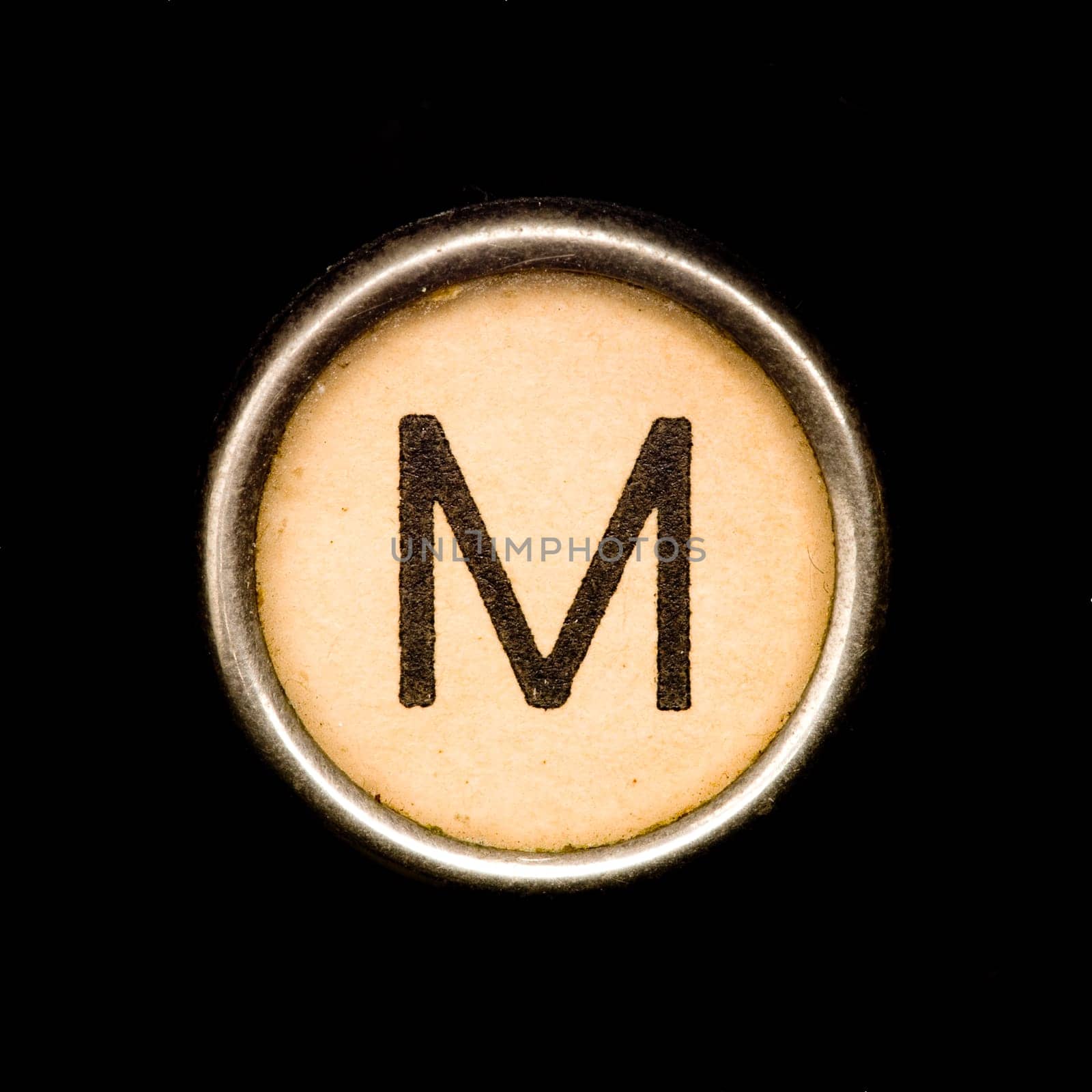 The M button on a complete alphabet of an antique typewriter
