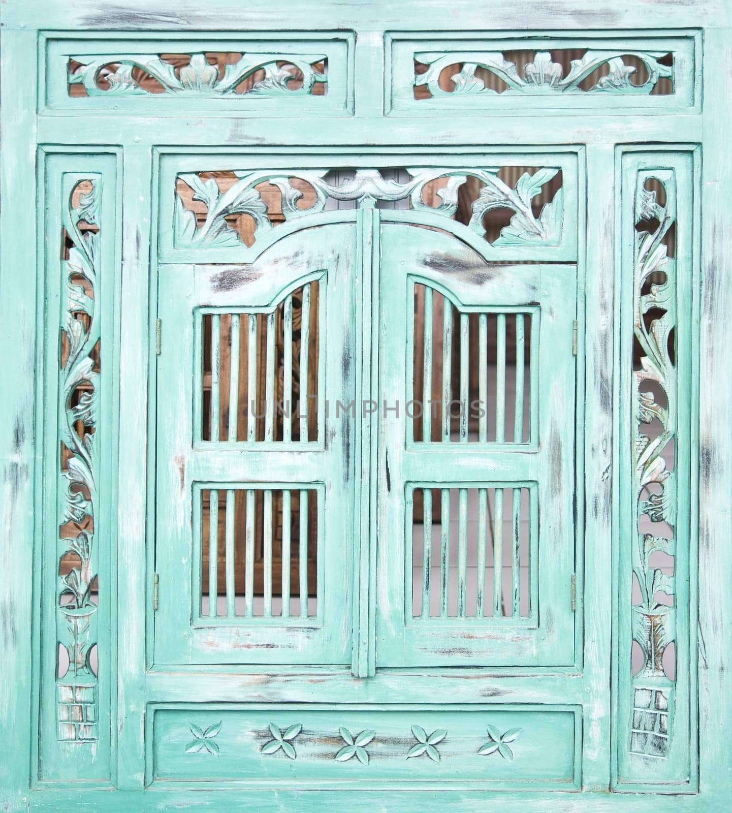 Traditional Indonesian wood carved window with shutters