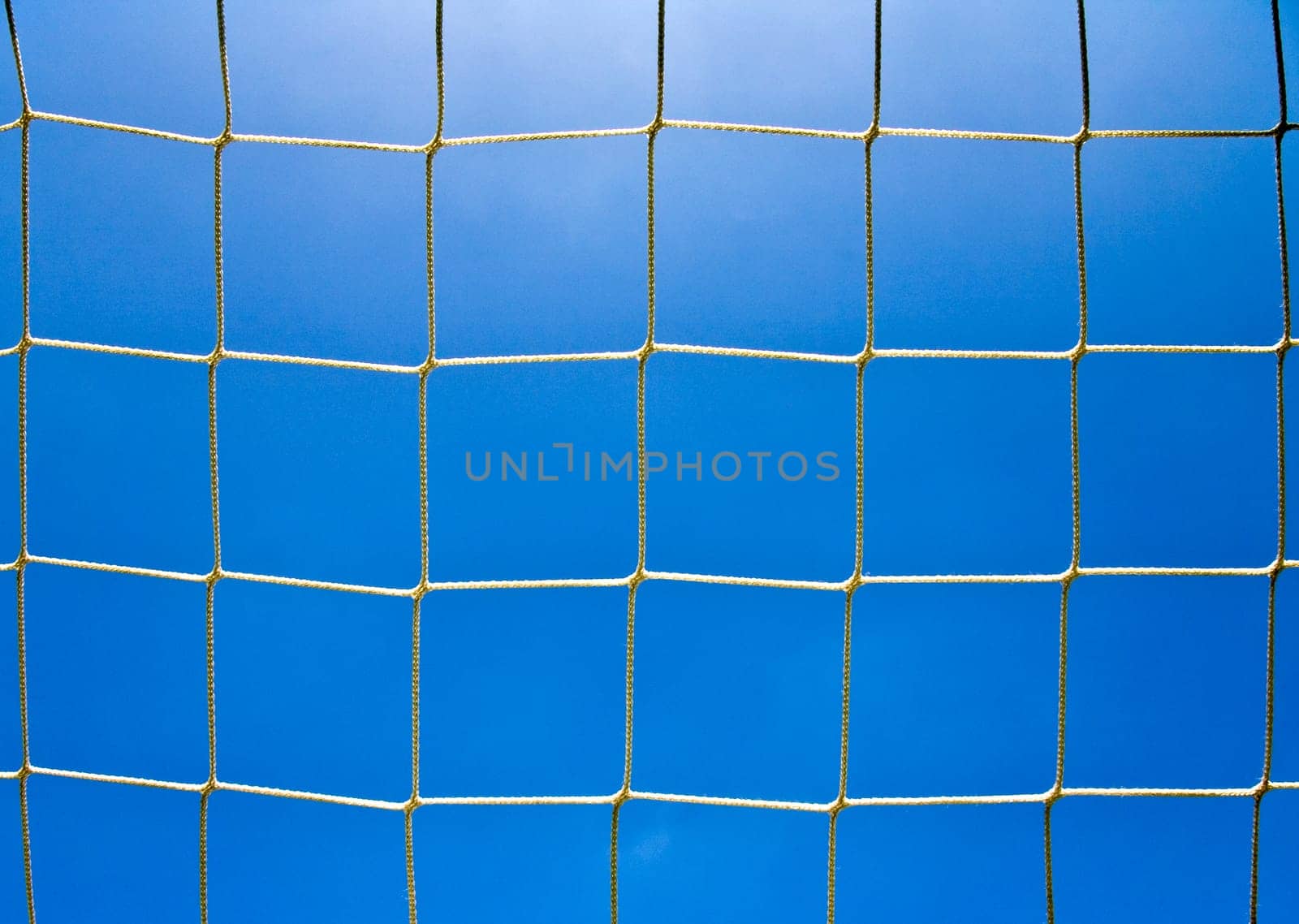 Soccer goal net with a sky background