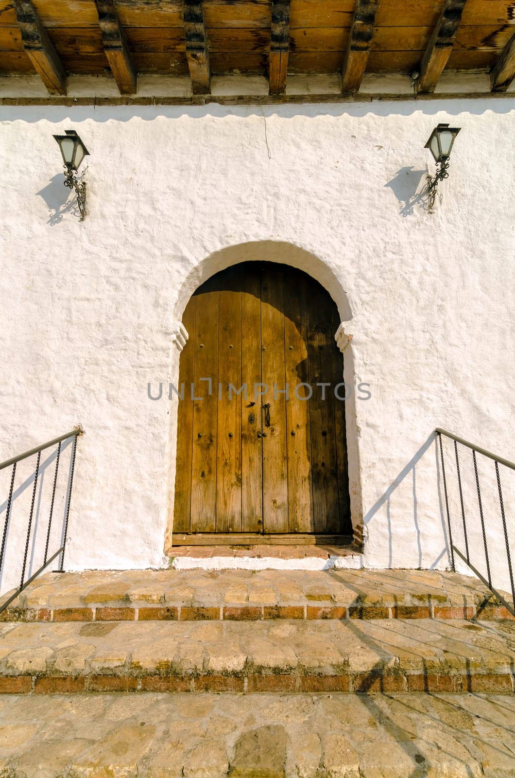 Old wooden door with white colonial wall