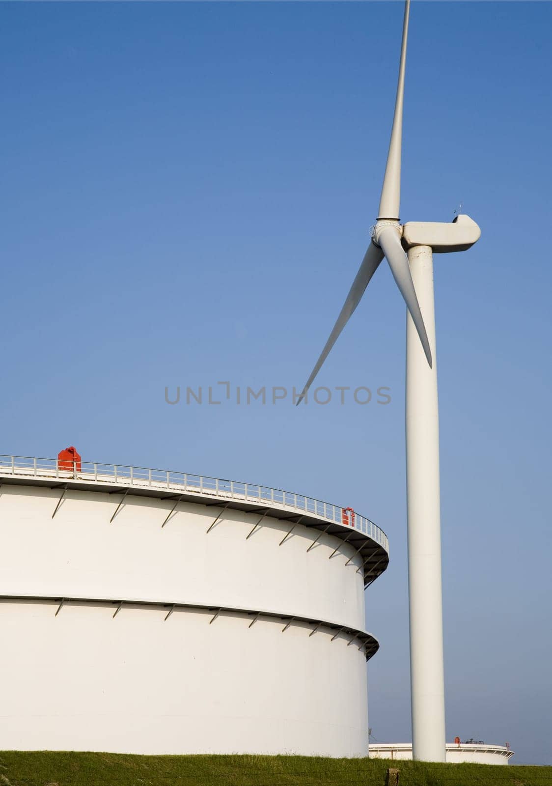 Oil storage and modern wind turbine in the Port of Rotterdam, Holland
