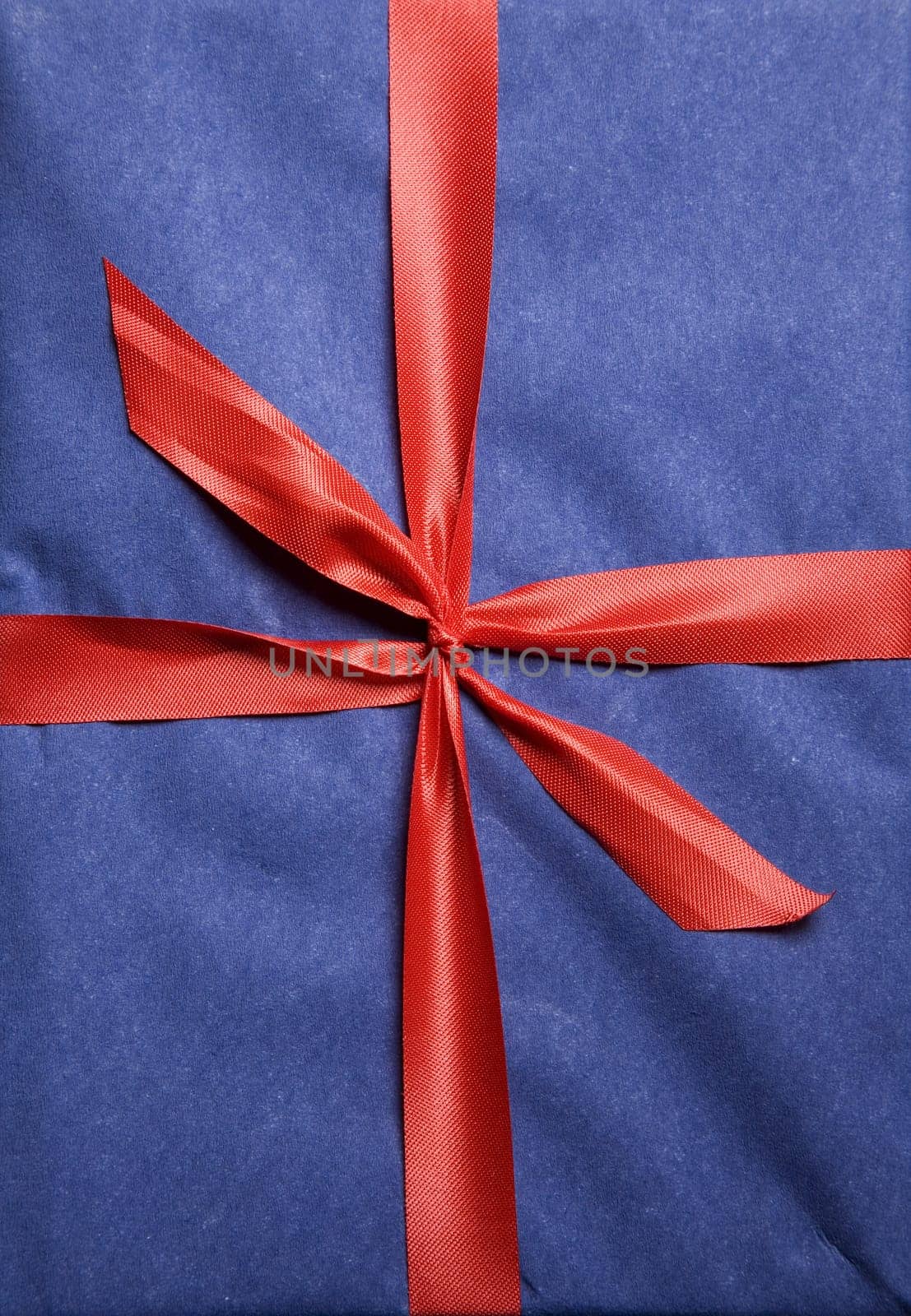 Christmas present wrapped in red ribbon