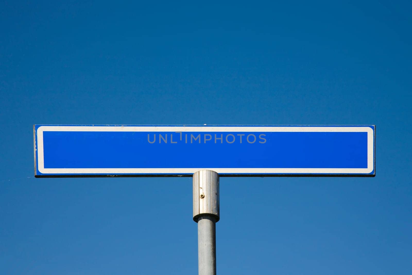 Road sign against a blue sky