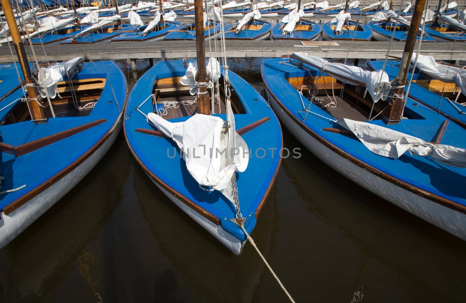Many blue sailing boats in the marina