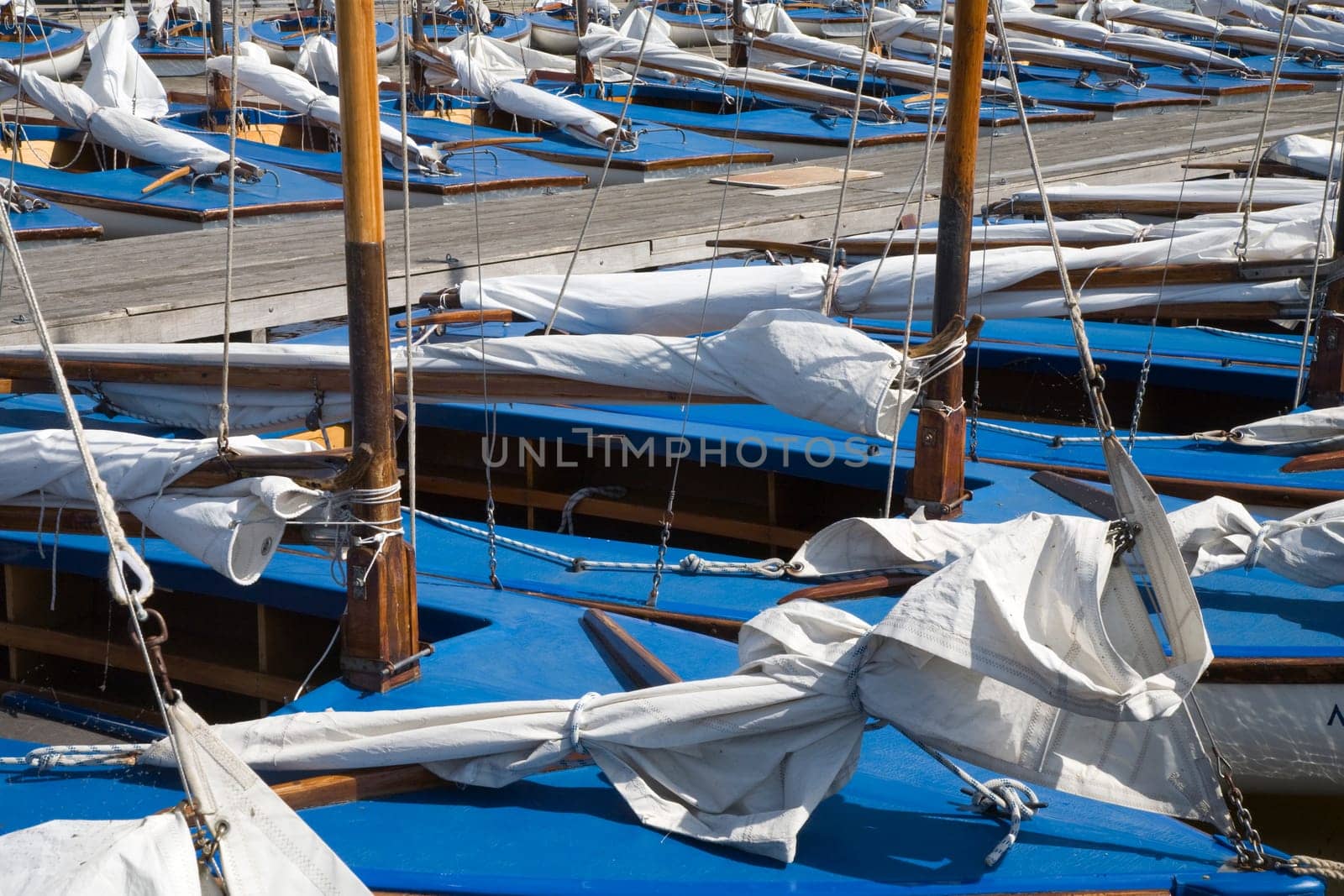 Many blue sailing boats in the marina