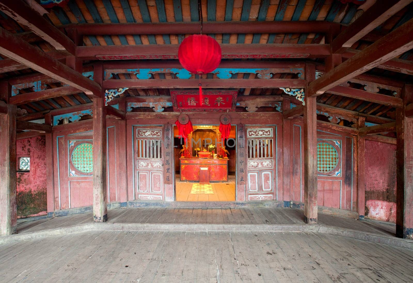 Interior of the Japanese covered bridge with buddhist pagoda attached to one side in Hoi An, Vietnam