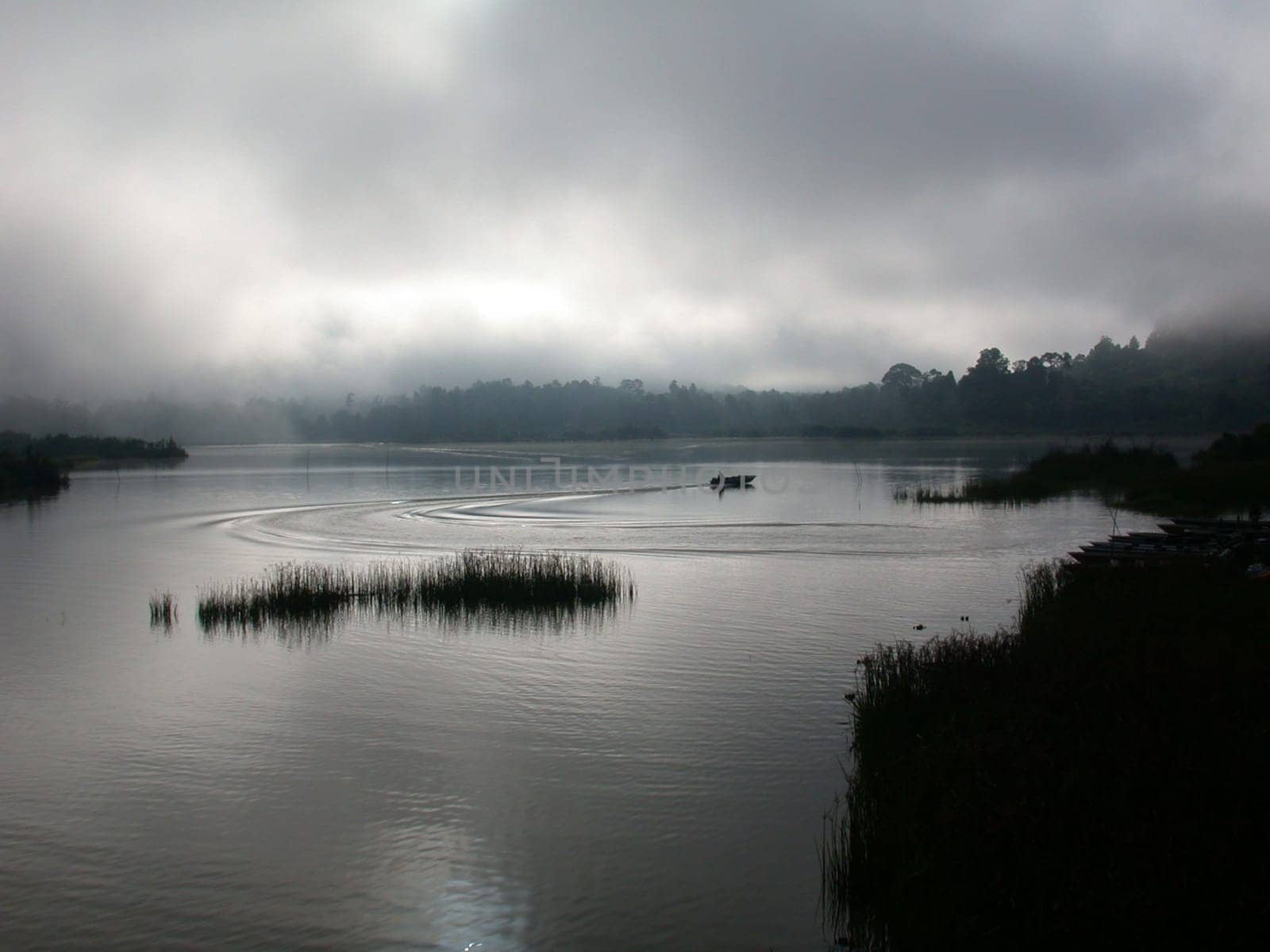A misty sunset over a lake in Malaysia
