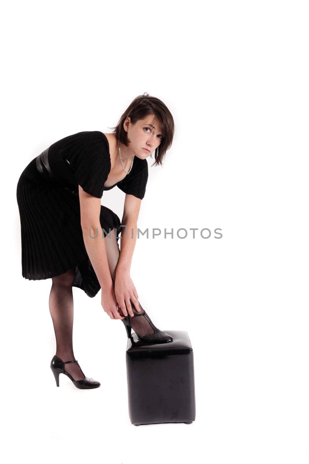 young brunette woman looking like a nanny or widow wearing a black shoe