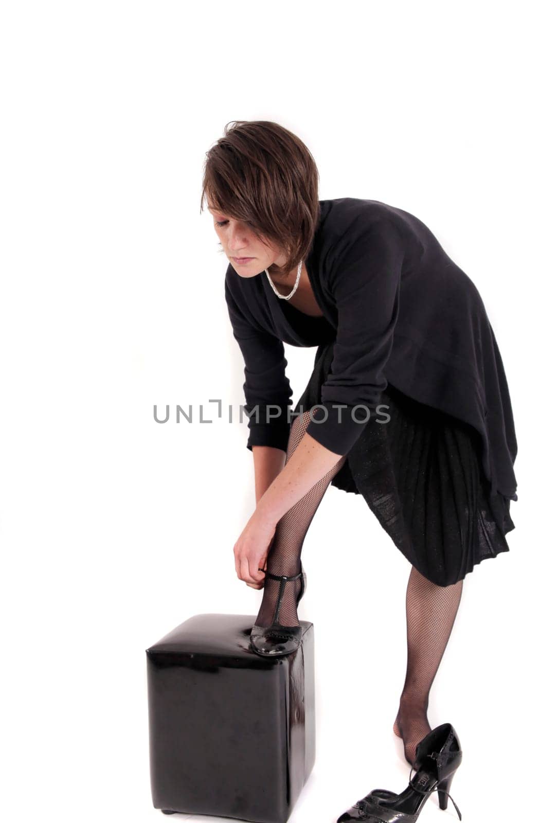 young brunette woman looking like a nanny or widow wearing a black shoe