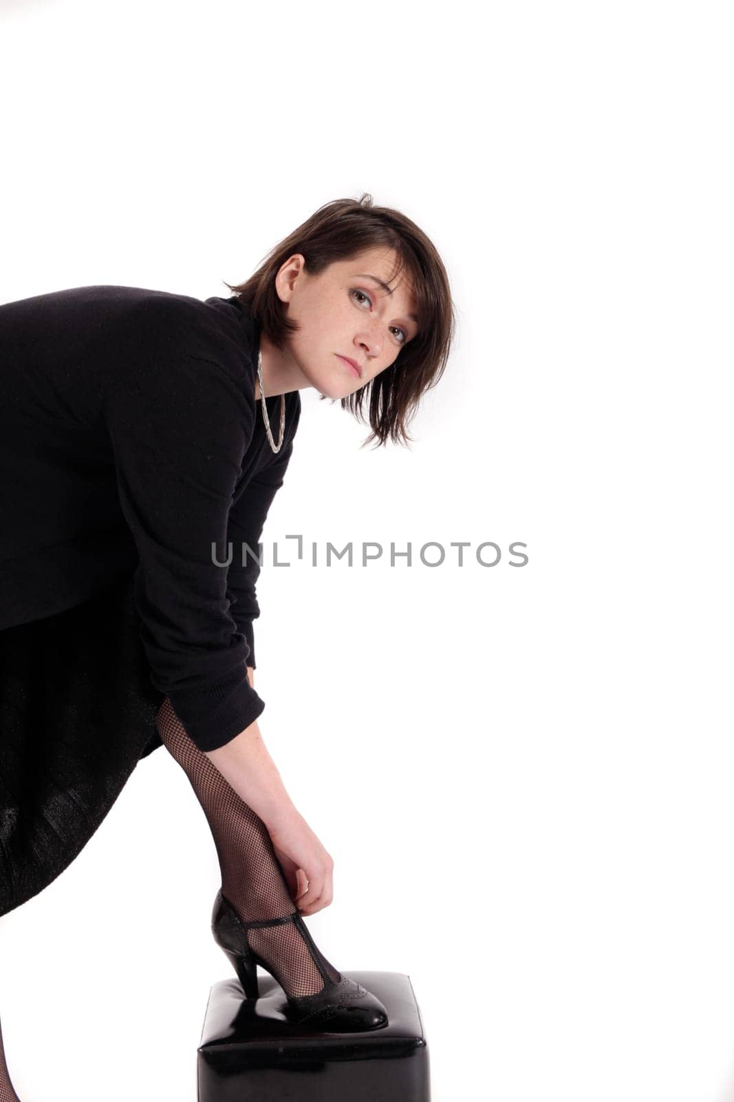 young brunette woman looking like a nanny or widow wearing a black shoe