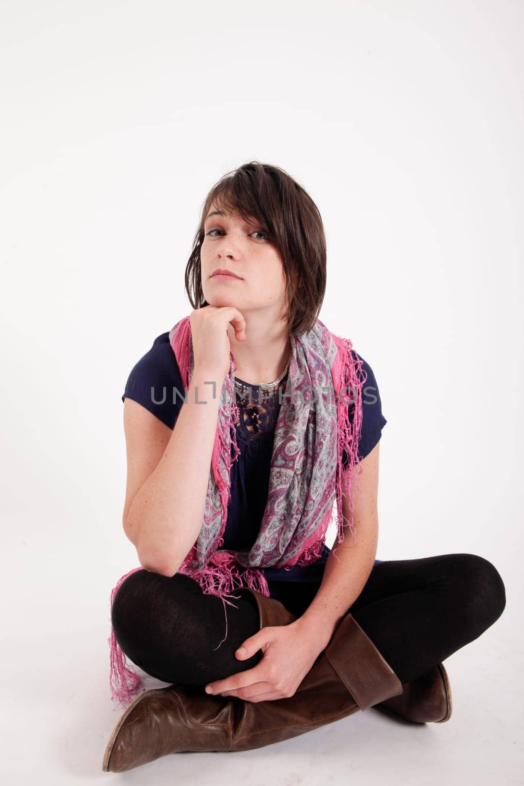 variation of expression on the face of a young brunette woman in studio with a colored scarf