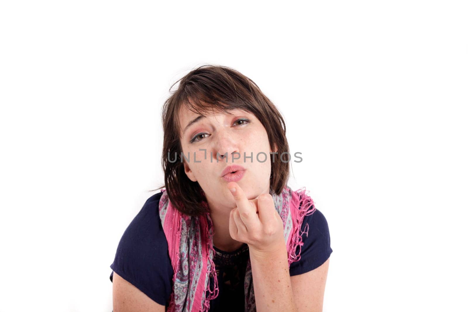 humorous portrait of a young brunette woman with finger of her mouth, colored scarf