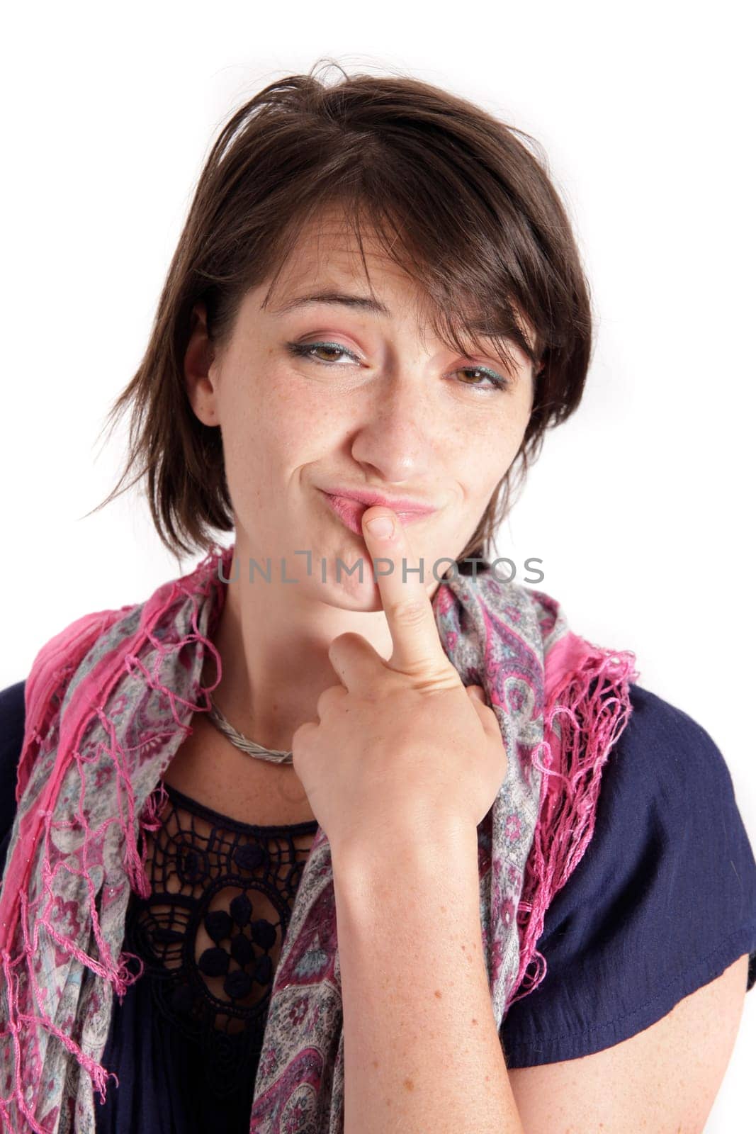 humorous portrait of a young brunette woman with finger of her mouth, colored scarf