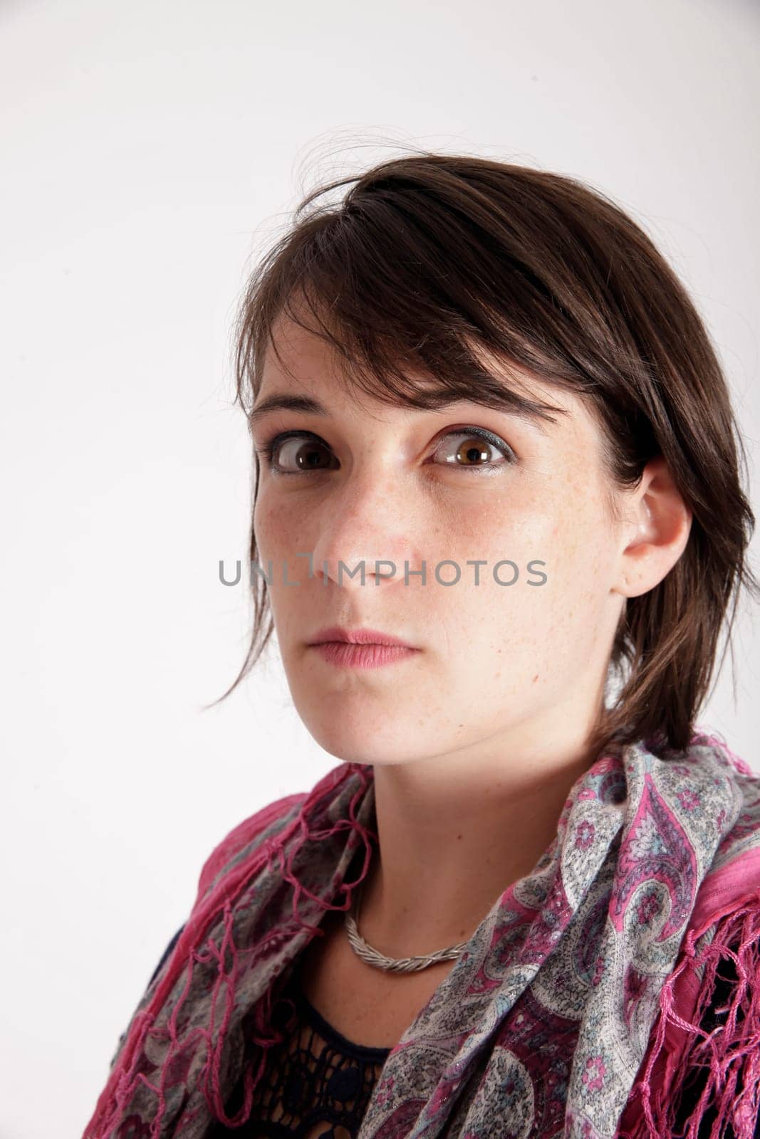 portrait of a young brunette woman with colored scarf looking ahead