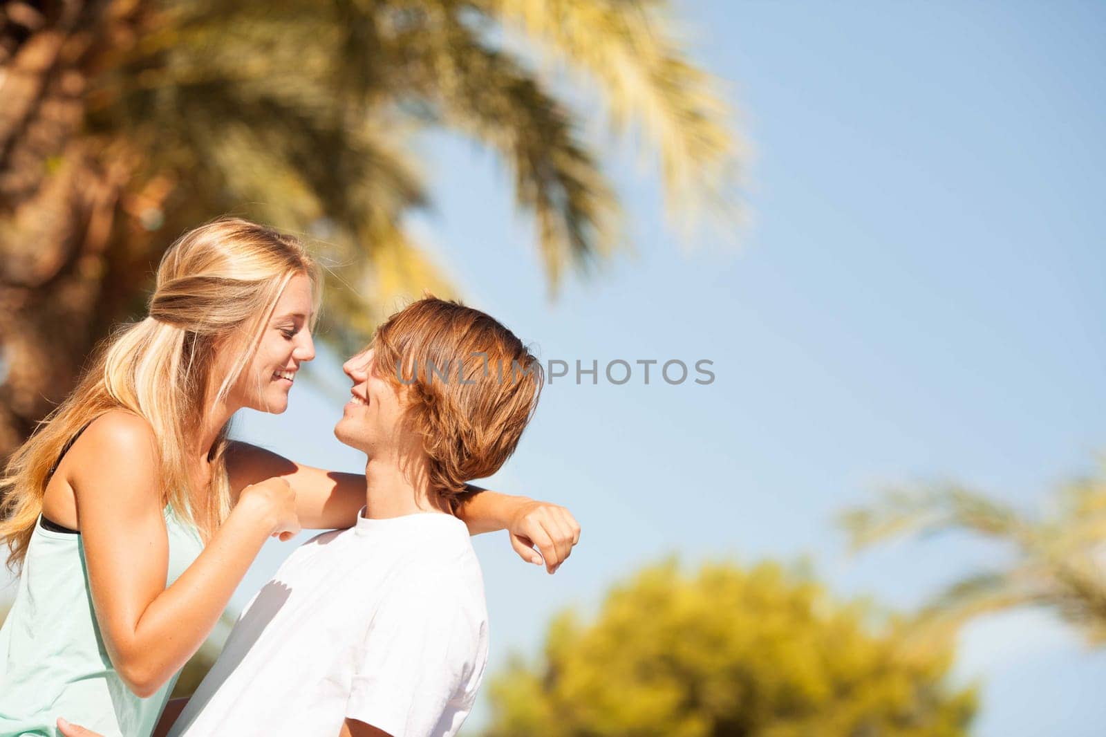 Young romantic beautiful couple enjoying on a walkside with threes