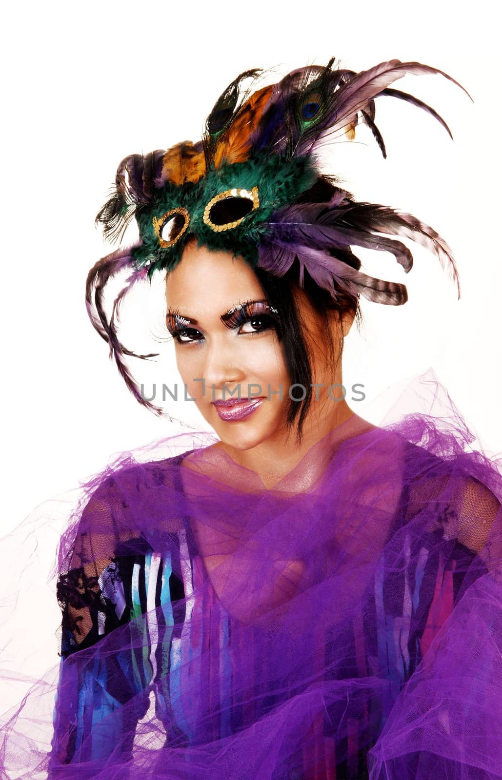 A young woman in a colorful blouse and lilac twill around her body,  with a father mask on her forehead on white background.