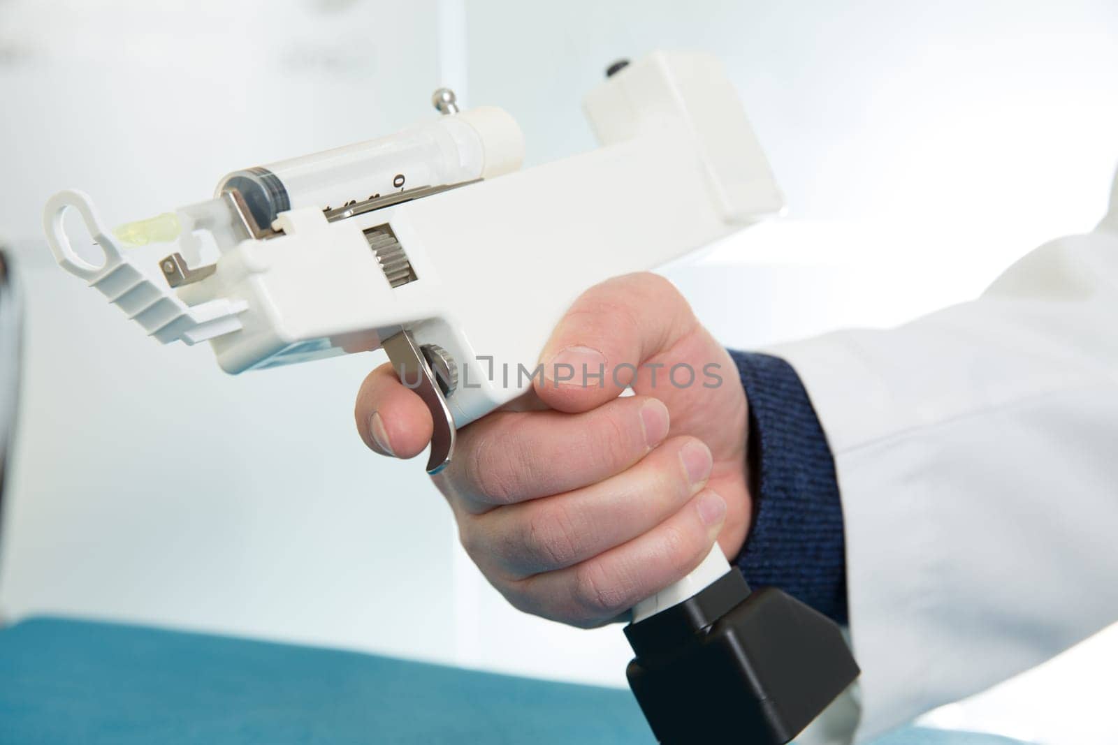 mesotherapy gun electronic with syringe on doctor hands