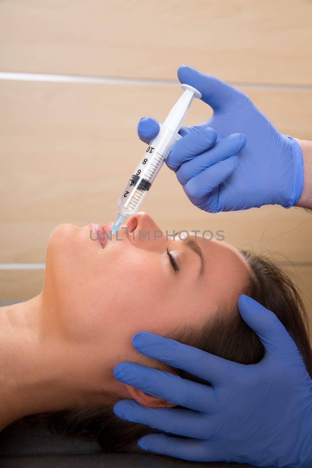 Anti aging facial mesotherapy with syringe closeup  on woman face