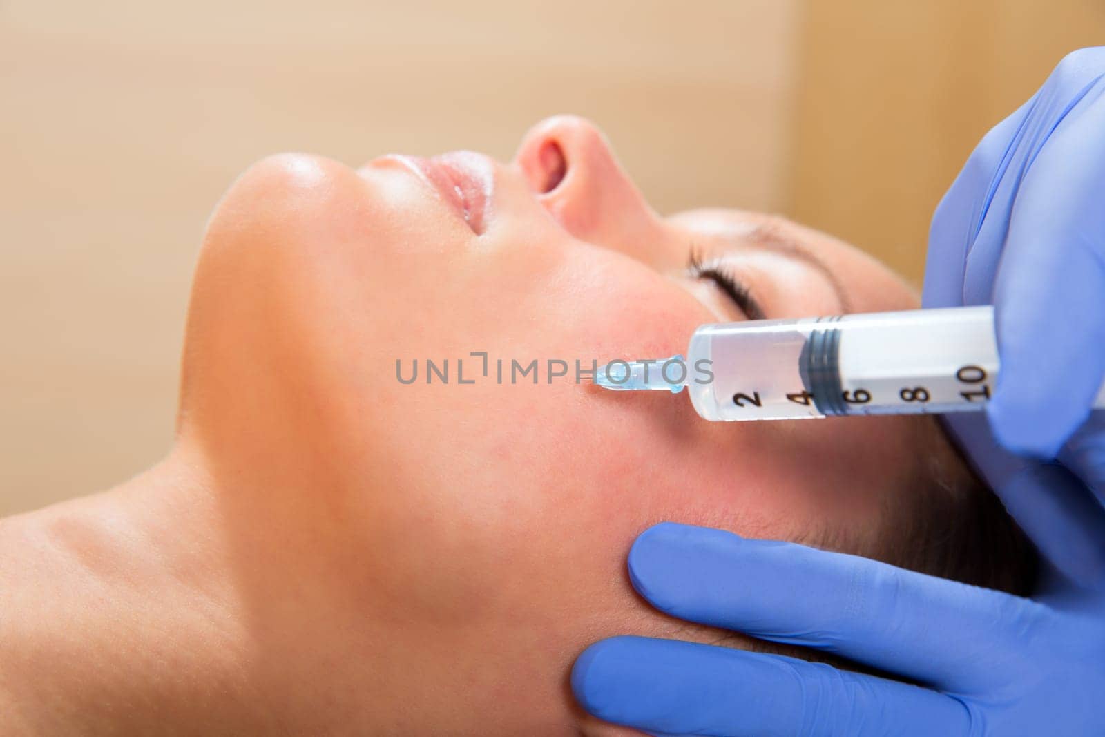 Anti aging facial mesotherapy with syringe closeup  on woman face