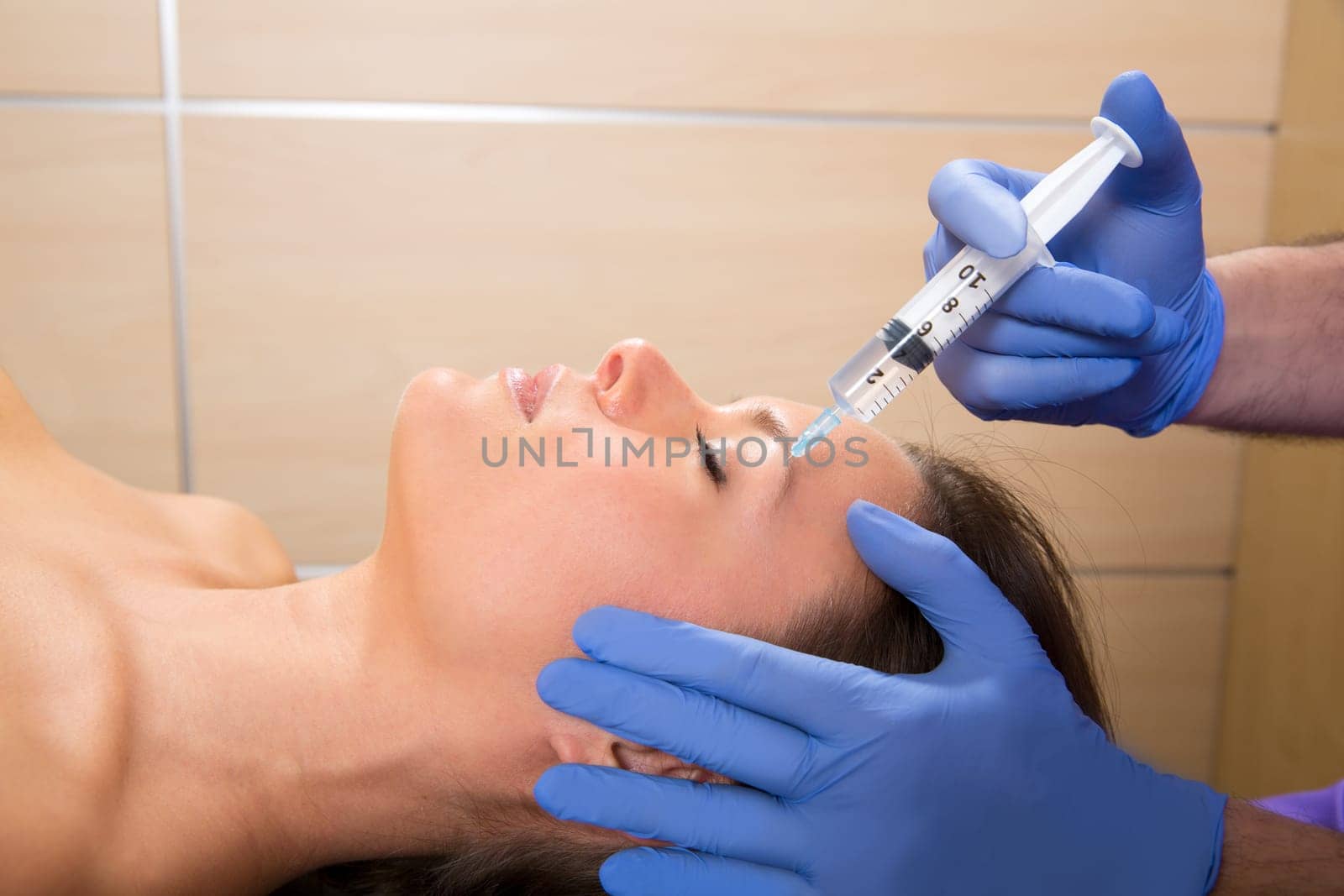 Anti aging facial mesotherapy with syringe closeup  on woman face